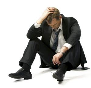 Executive sitting on floor looking distraught