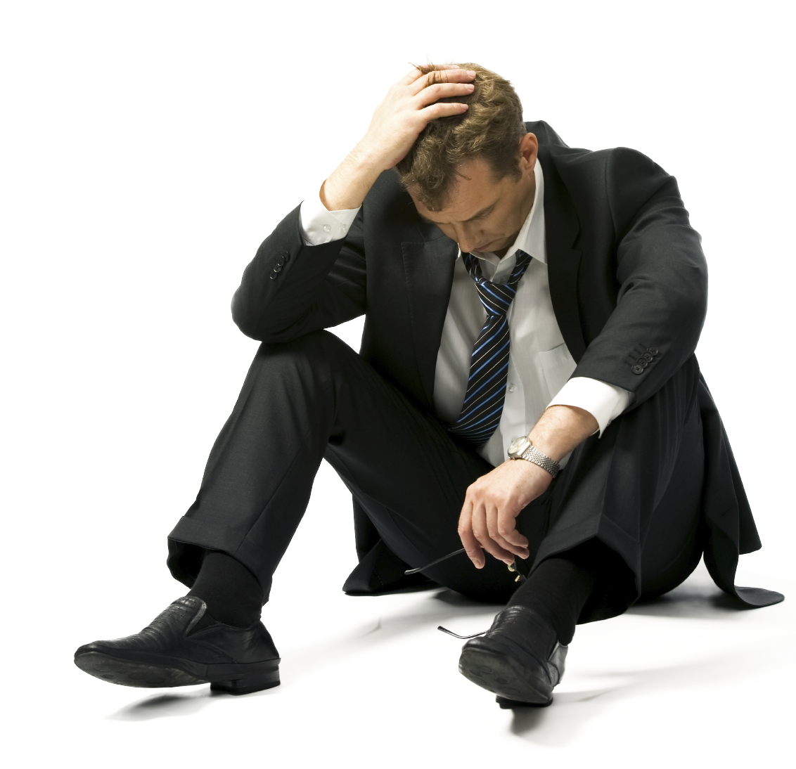 Executive sitting on floor looking distraught